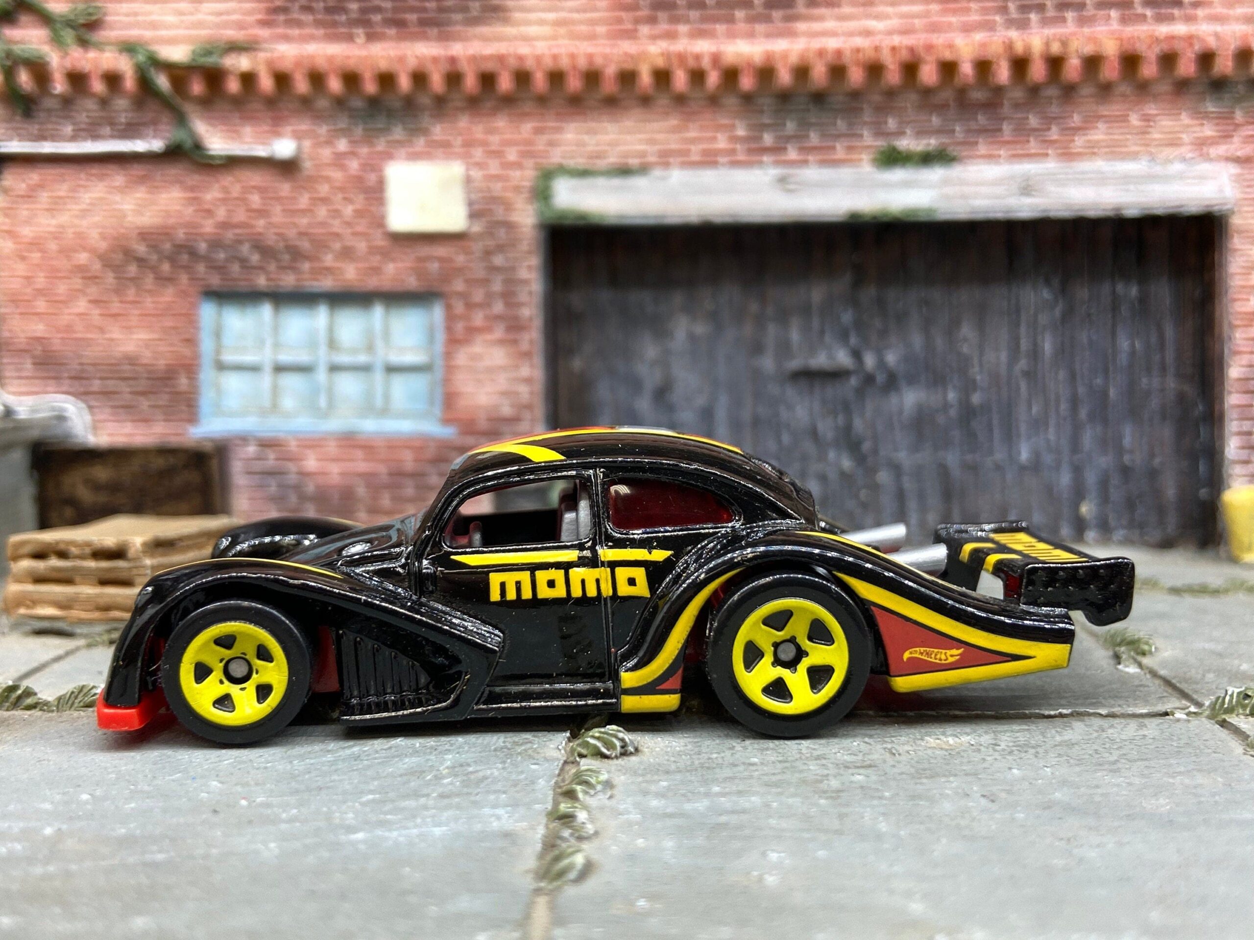 Hot Wheels VW Käfer Racer in black, red and yellow Momo livery, shown loose
