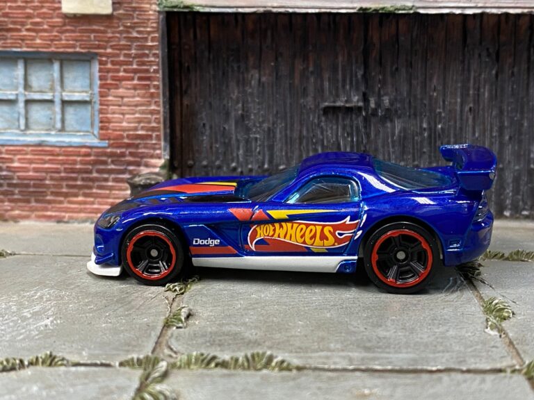 Left side of the blue Hot Wheels Dodge Viper ACR with orange-rimmed wheels and a large Hot Wheels logo